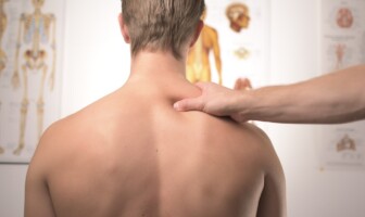 Wellness Wednesday: Avoiding Shoulder Injuries from Repetitive Movements Man receiving neck and shoulder treatment at physical therapist